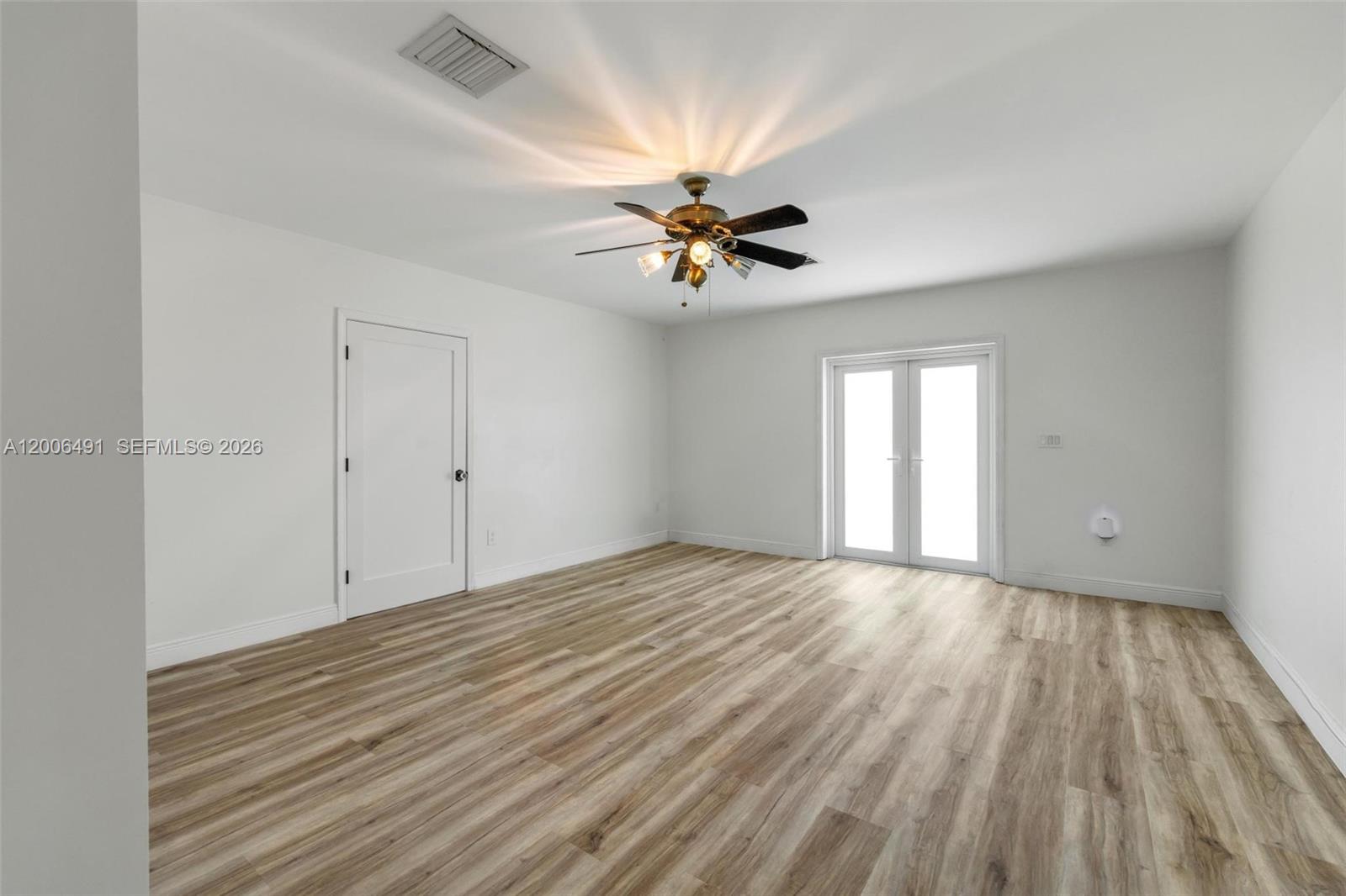 22275 Southwest 256th Street Homestead, FL 33031 - Photo 17 of 57 a view of empty room with wooden floor and fan