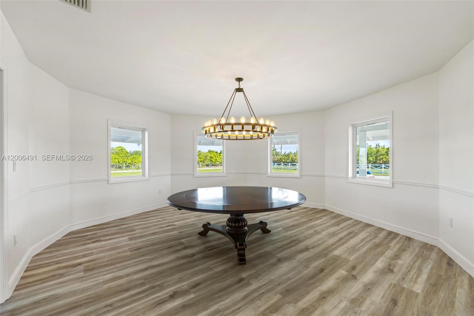 22275 Southwest 256th Street Homestead, FL 33031 - Photo 41 of 57 a workspace with wooden floor and a window
