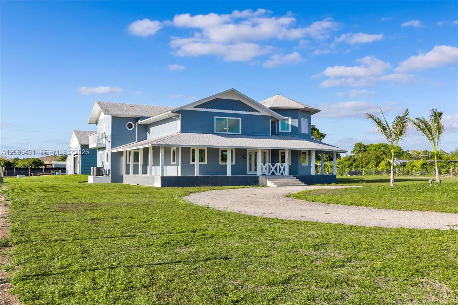 22275 Southwest 256th Street Homestead, FL 33031 - Photo 46 of 57 a front view of a house with a yard table and chairs
