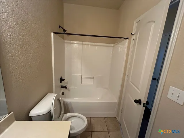 a bathroom with a toilet and a bathtub