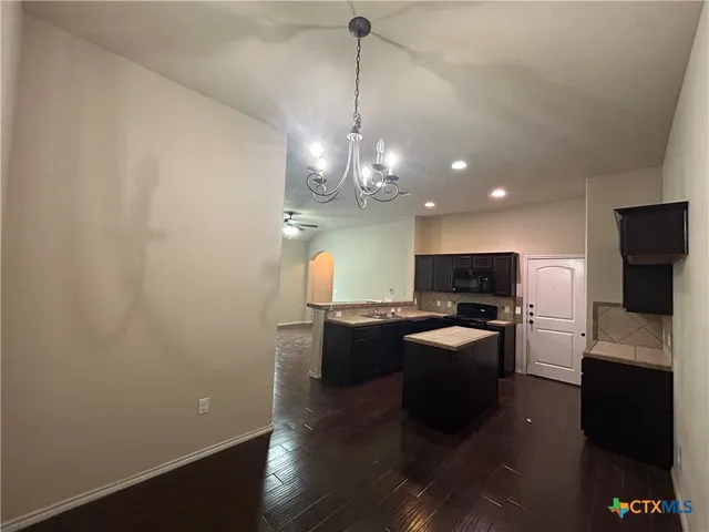a kitchen with sink a microwave and refrigerator