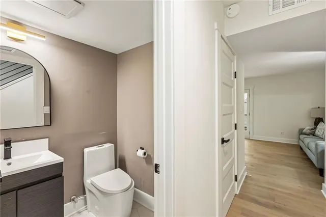a bathroom with a toilet sink and mirror