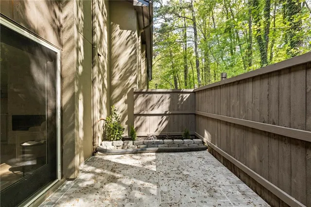 a backyard of a house with table and chairs