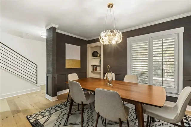 a view of a dining room with furniture and chandelier