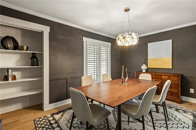 a dining room with furniture a chandelier and wooden floor