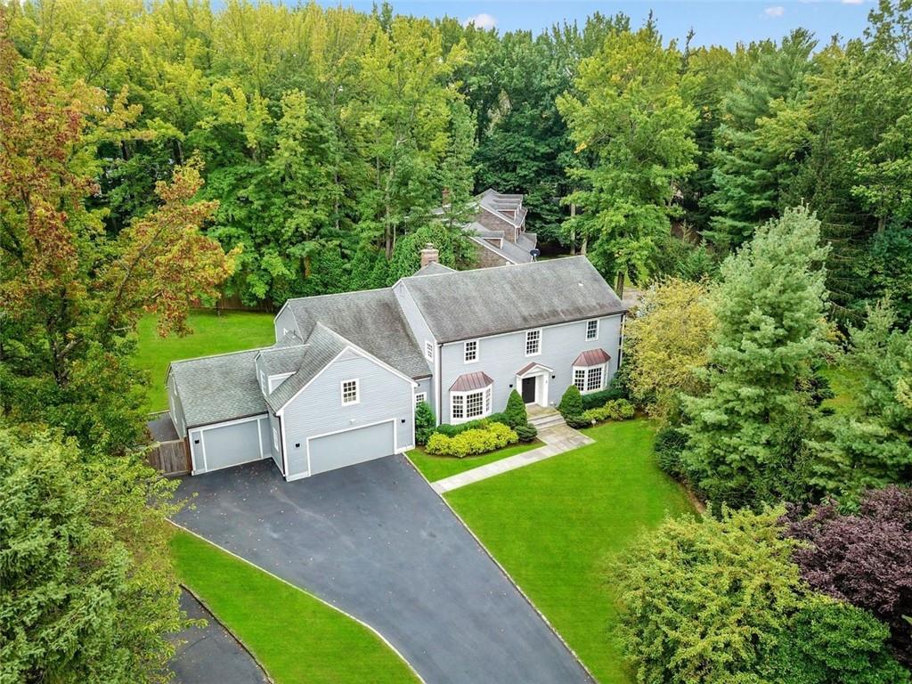 an aerial view of a house with a yard basket ball court and outdoor seating