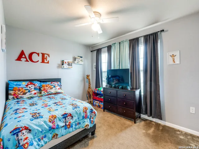 a bedroom with a bed and a dresser in it