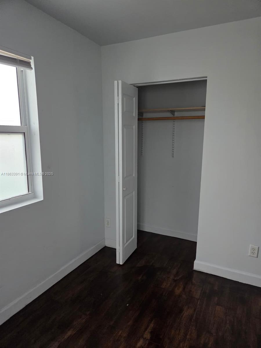 4351 Northeast 18th Avenue Pompano Beach, FL 33064 - Photo 11 of 18 an empty room with wooden floor and closet