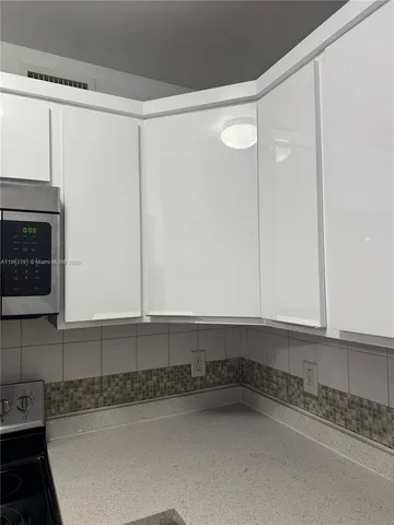 a view of a kitchen with a sink and cabinets