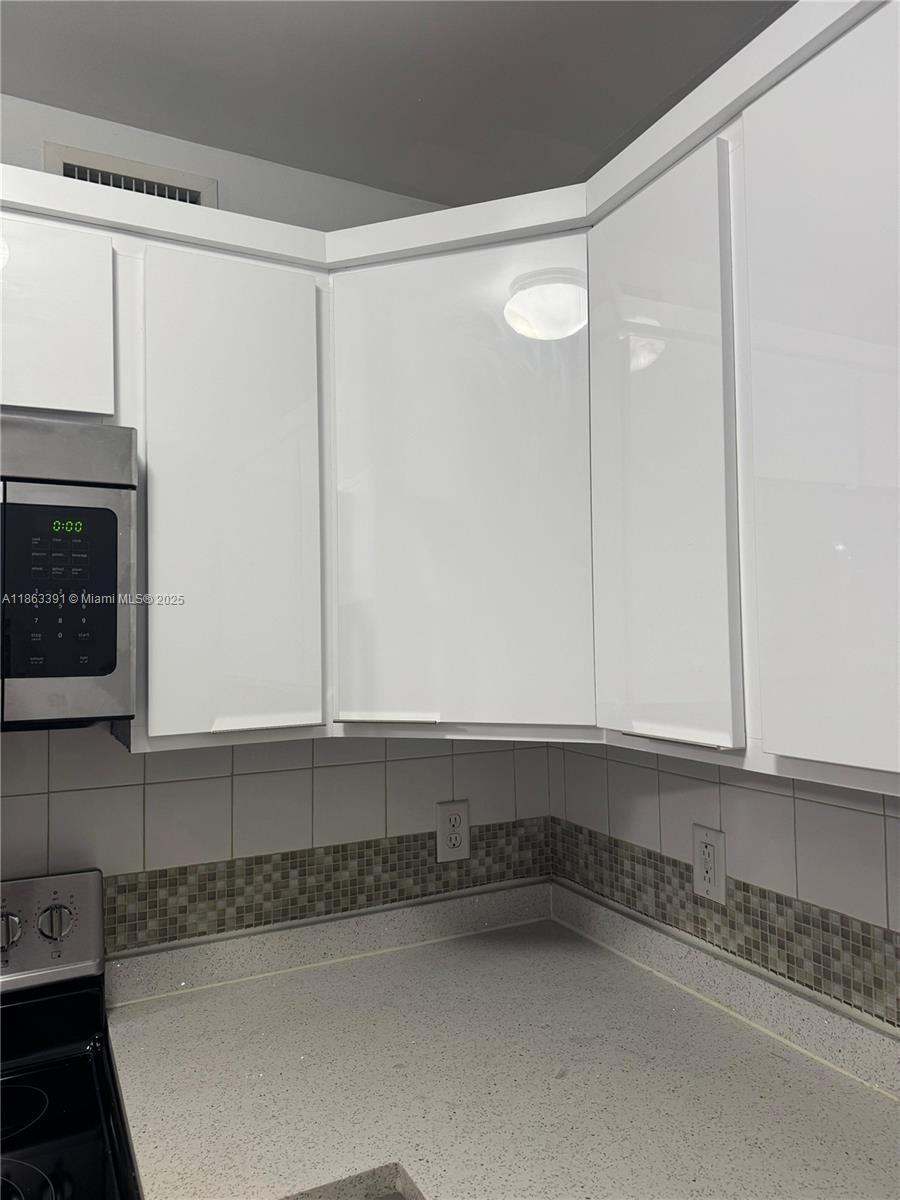 4351 Northeast 18th Avenue Pompano Beach, FL 33064 - Photo 5 of 18 a view of a kitchen with a sink and cabinets