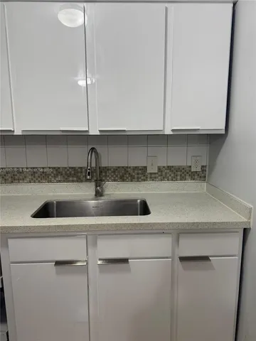 a kitchen with a sink and cabinets