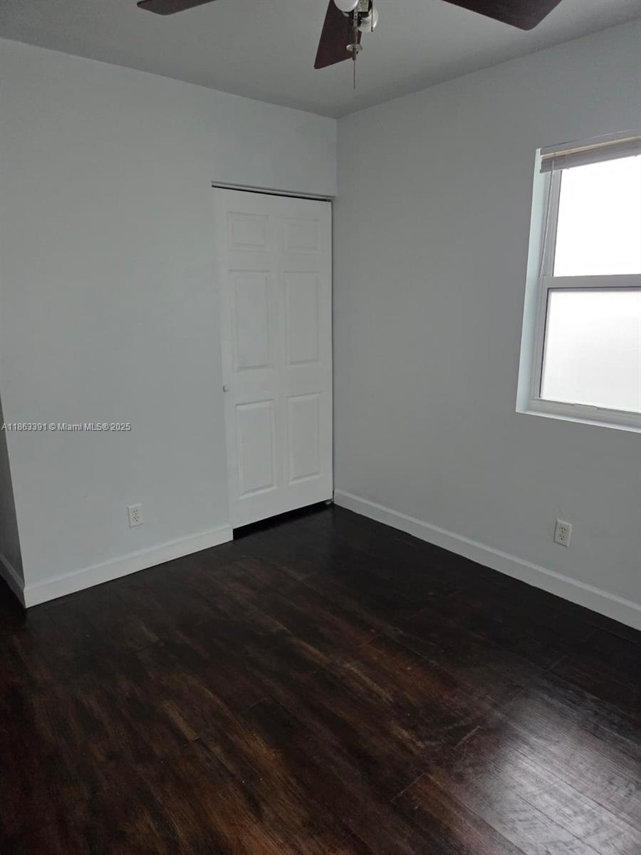 4351 Northeast 18th Avenue Pompano Beach, FL 33064 - Photo 9 of 18 an empty room with wooden floor and windows
