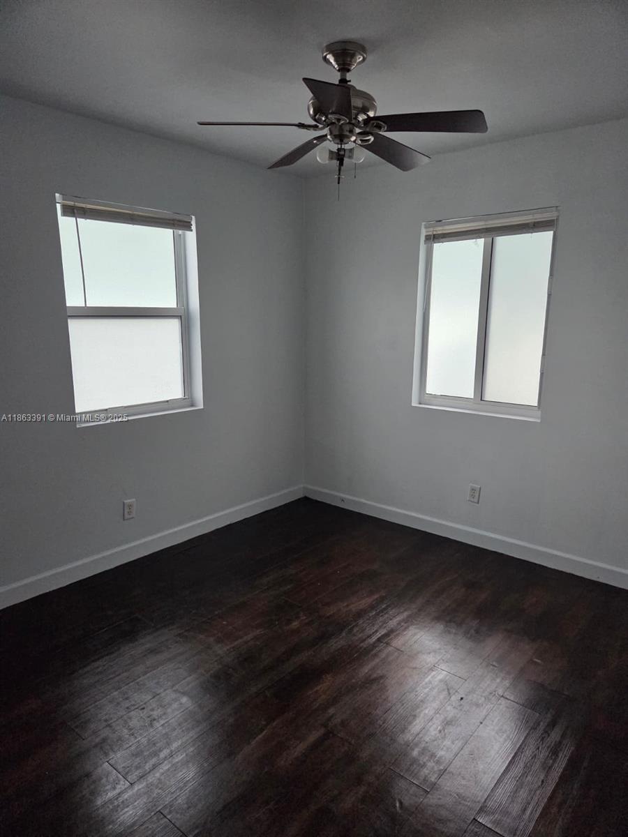 4351 Northeast 18th Avenue Pompano Beach, FL 33064 - Photo 10 of 18 a view of an empty room with wooden floor and a window