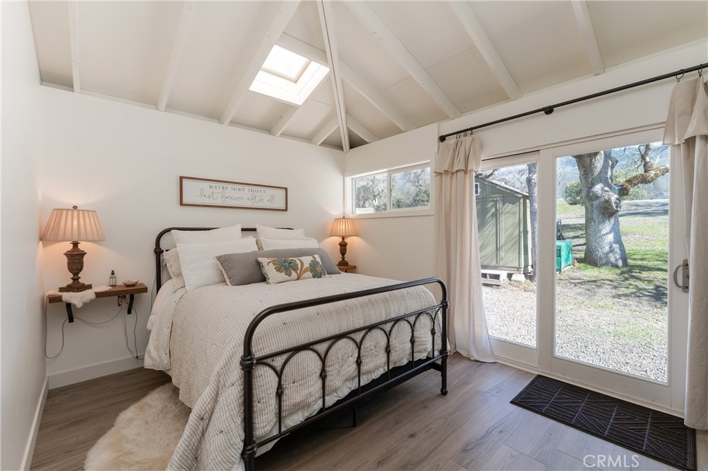 30429 Ridgewood Drive Potter Valley, CA 95469 - Photo 17 of 38 a bedroom with a large bed and wooden floor