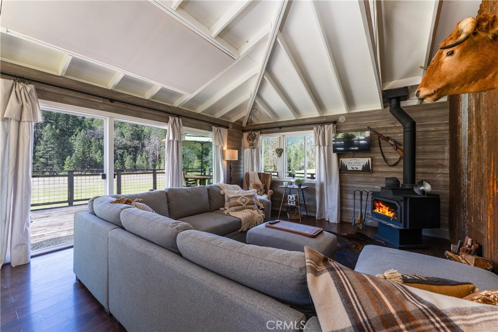 30429 Ridgewood Drive Potter Valley, CA 95469 - Photo 7 of 38 a living room with furniture a fireplace and a floor to ceiling window