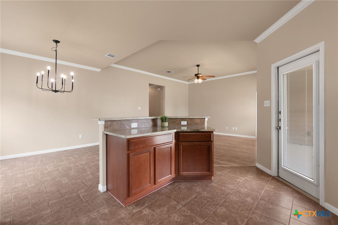 408 Copper Ridge Loop Temple, TX 76502 - Photo 18 of 39 Seamless flow between the kitchen and dining with easy access to the rear patio