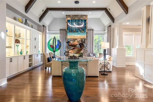 a view of a living room and dining room with wooden floor