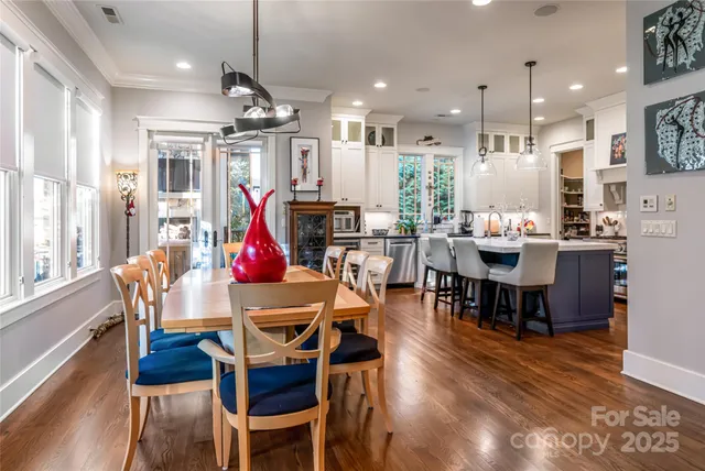 a view of a dining room with furniture wooden floor and chandelier