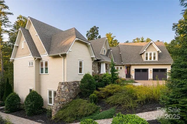a view of a white house next to a yard