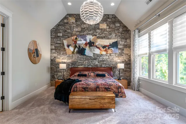 a bedroom with furniture a bed and a chandelier