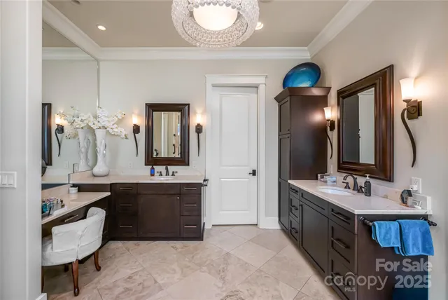 a bedroom with bed and a chandelier