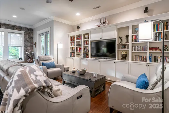 a living room with furniture and large windows