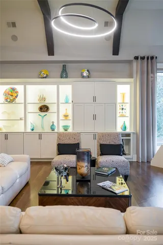 a living room with furniture and painting on the wall