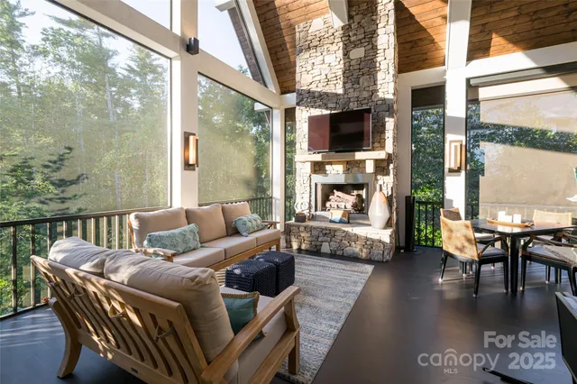 a living room with fireplace furniture and a large window