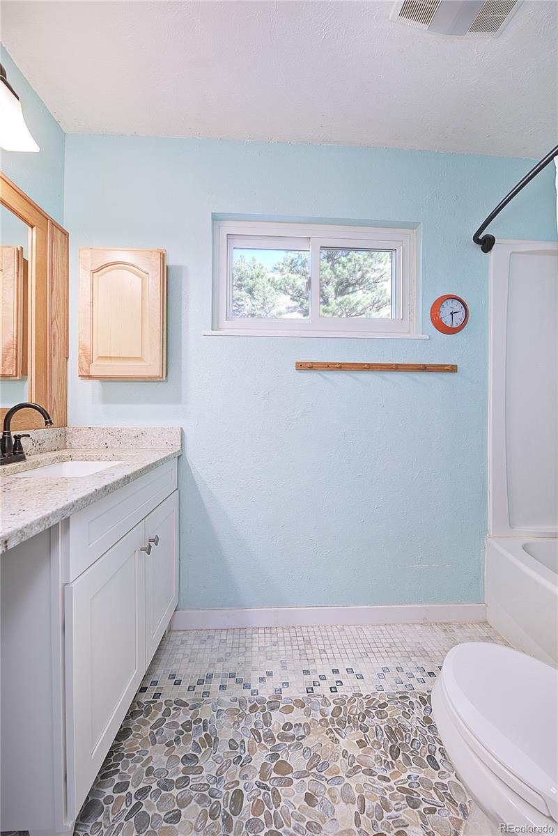 5384 Olde Stage Road Boulder, CO 80302 - Photo 11 of 28 a bathroom with a sink a toilet and a window
