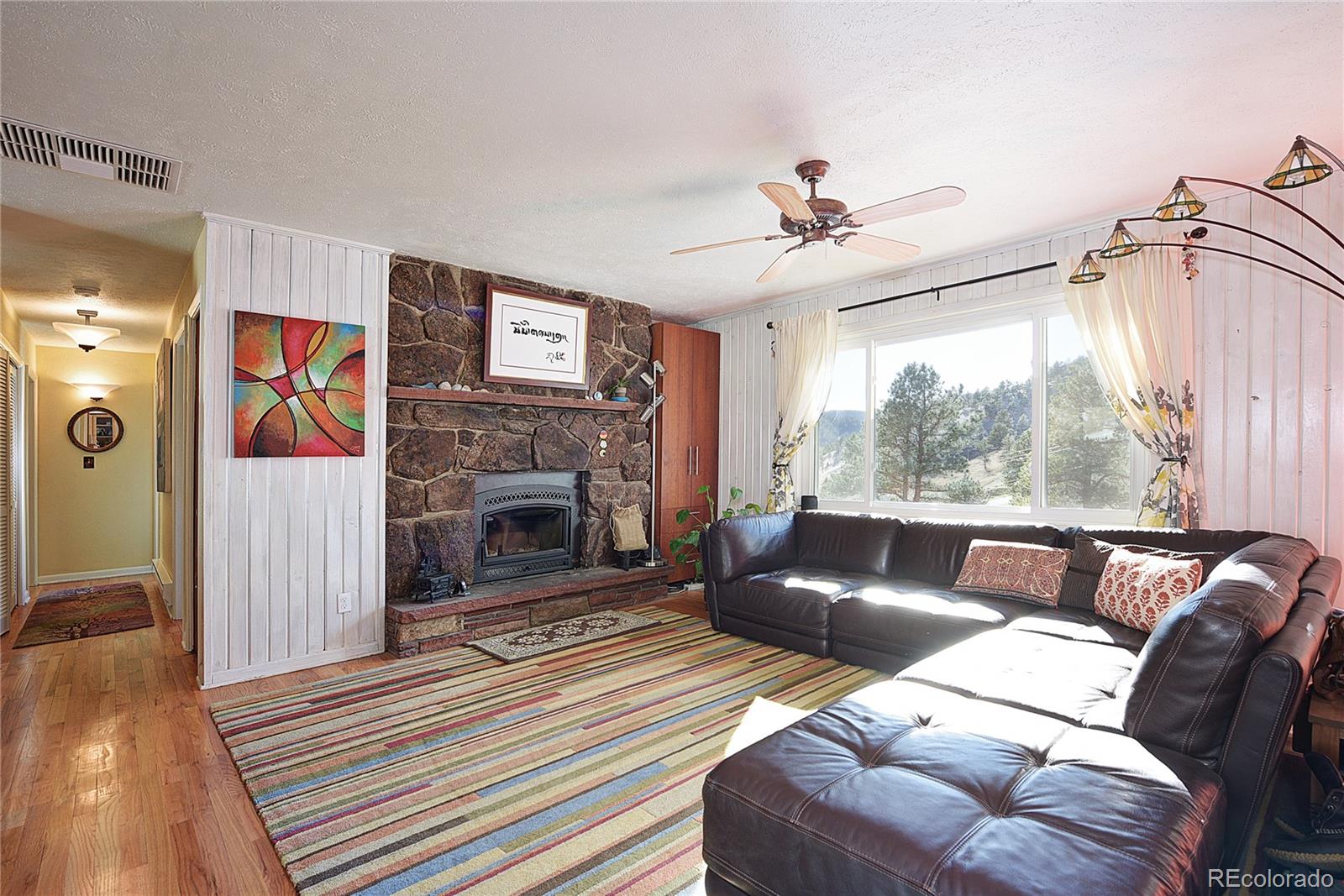 5384 Olde Stage Road Boulder, CO 80302 - Photo 2 of 28 a living room with furniture and a fireplace