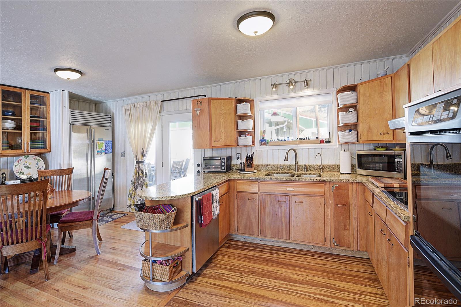 5384 Olde Stage Road Boulder, CO 80302 - Photo 4 of 28 a kitchen with stainless steel appliances granite countertop a stove and a refrigerator