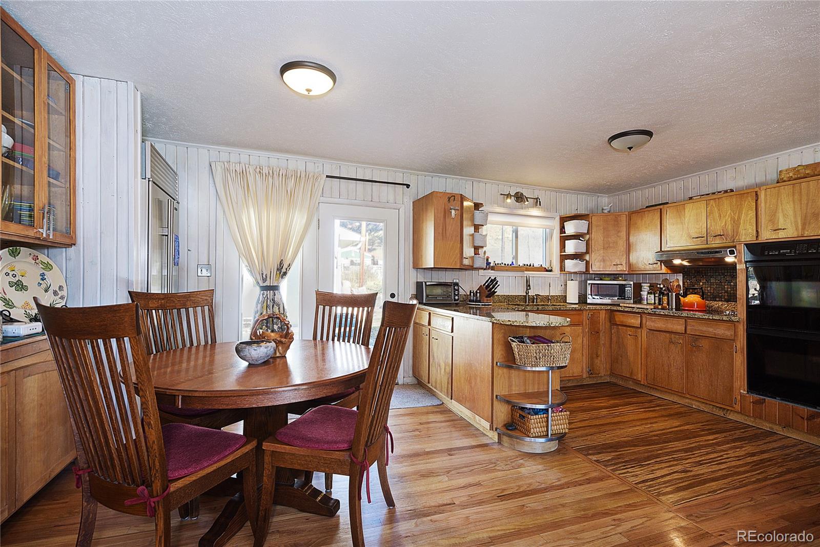 5384 Olde Stage Road Boulder, CO 80302 - Photo 6 of 28 a dining room with furniture and wooden floor