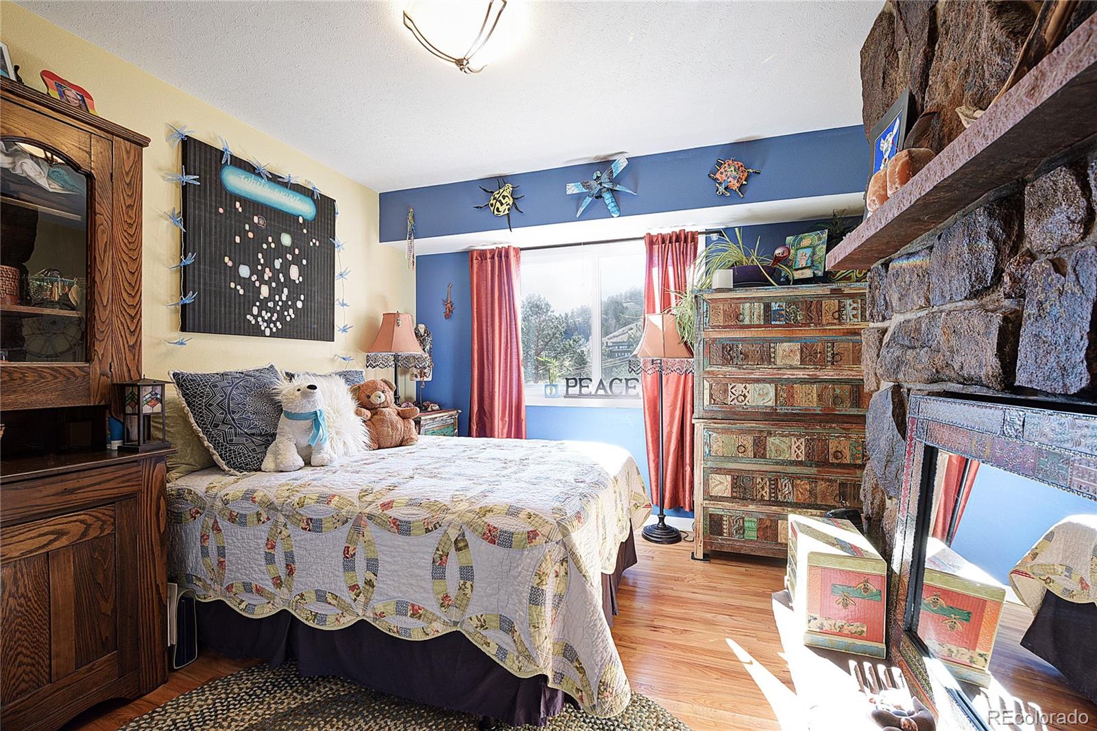 5384 Olde Stage Road Boulder, CO 80302 - Photo 7 of 28 a bedroom with a bed next to a large window with the outer view