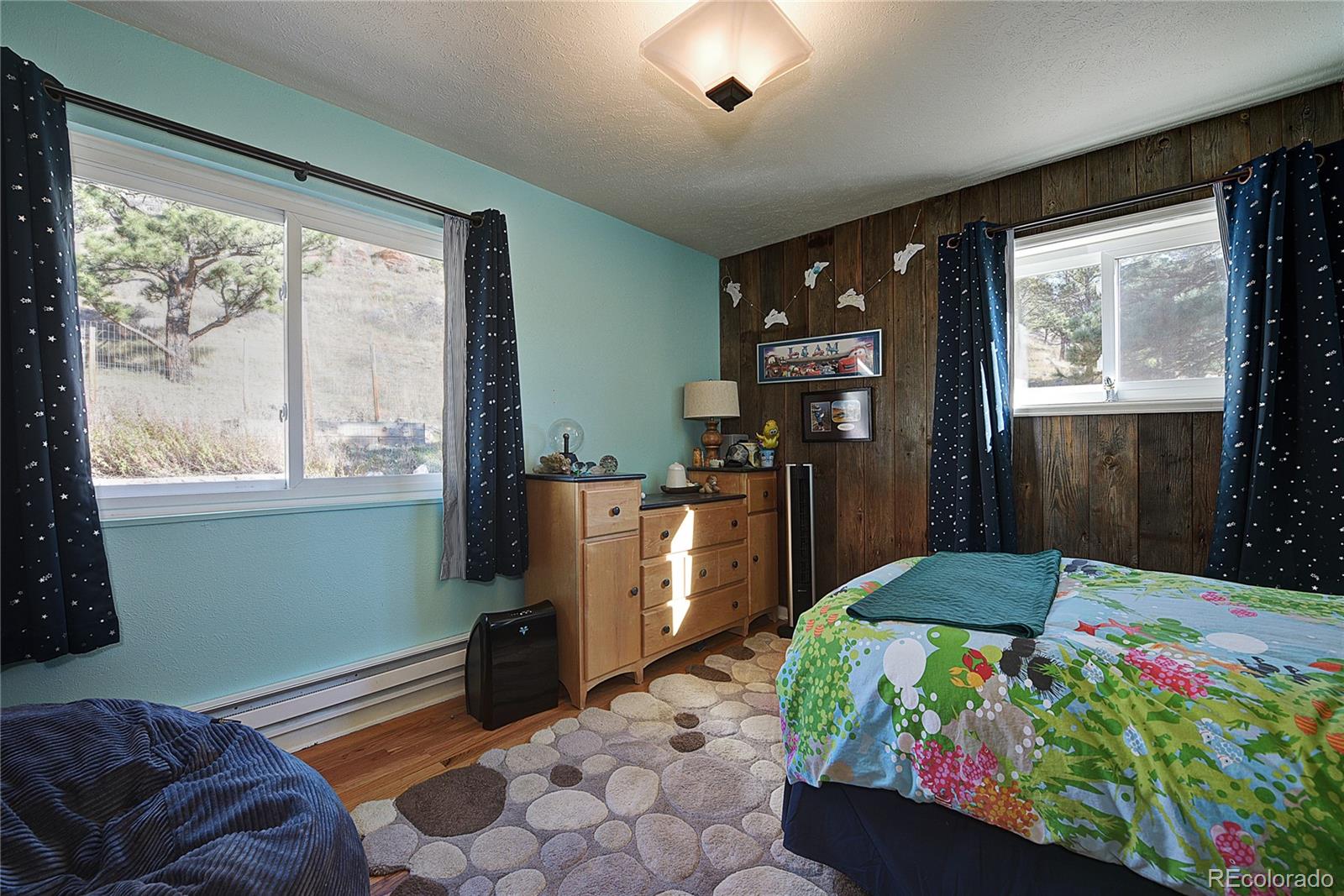 5384 Olde Stage Road Boulder, CO 80302 - Photo 9 of 28 a bed sitting in a bedroom next to a window