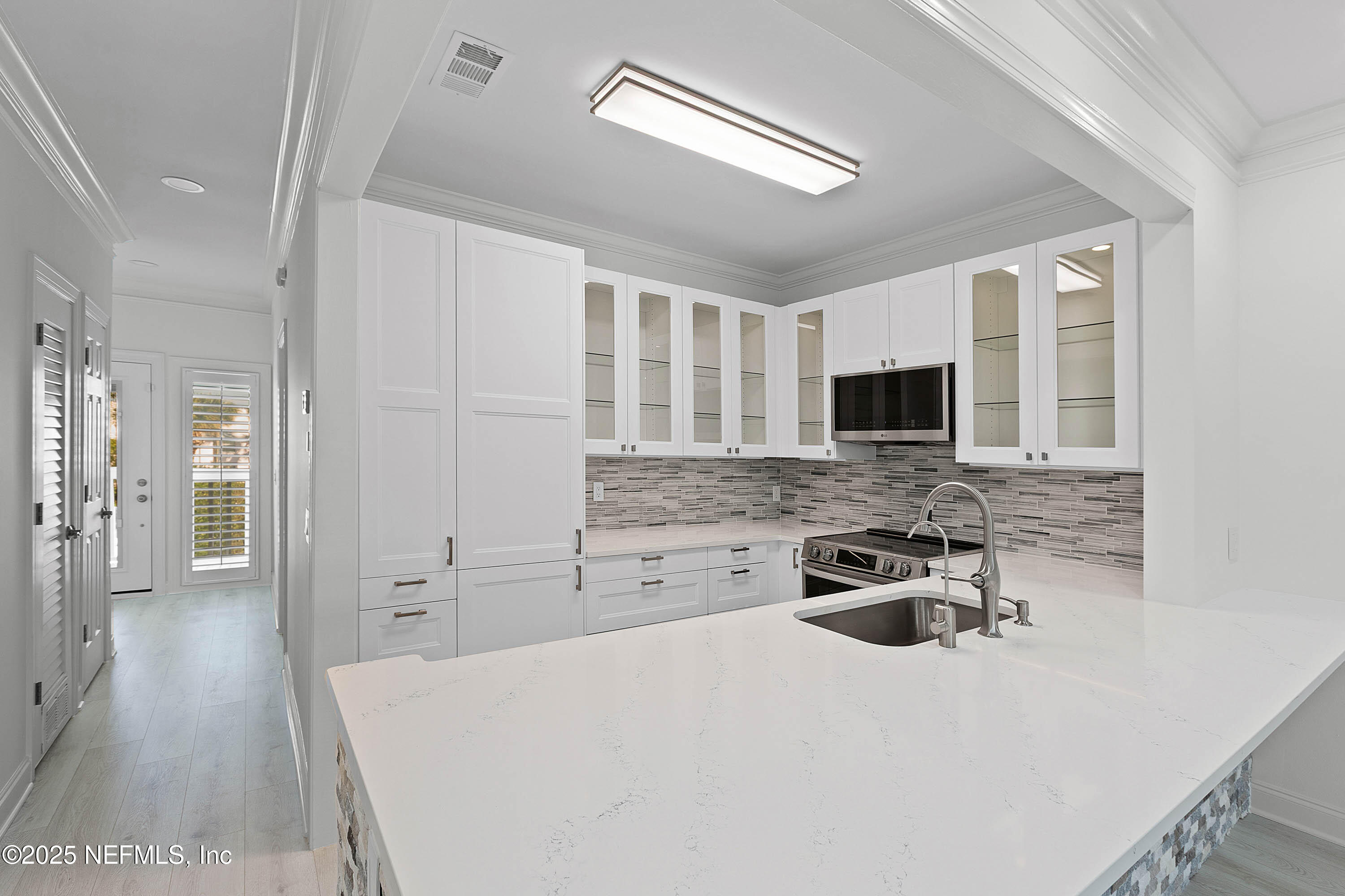 624 Ponte Vedra Boulevard, Unit C8 Ponte Vedra Beach, FL 32082 - Photo 3 of 26 a kitchen with a stove a sink and a microwave