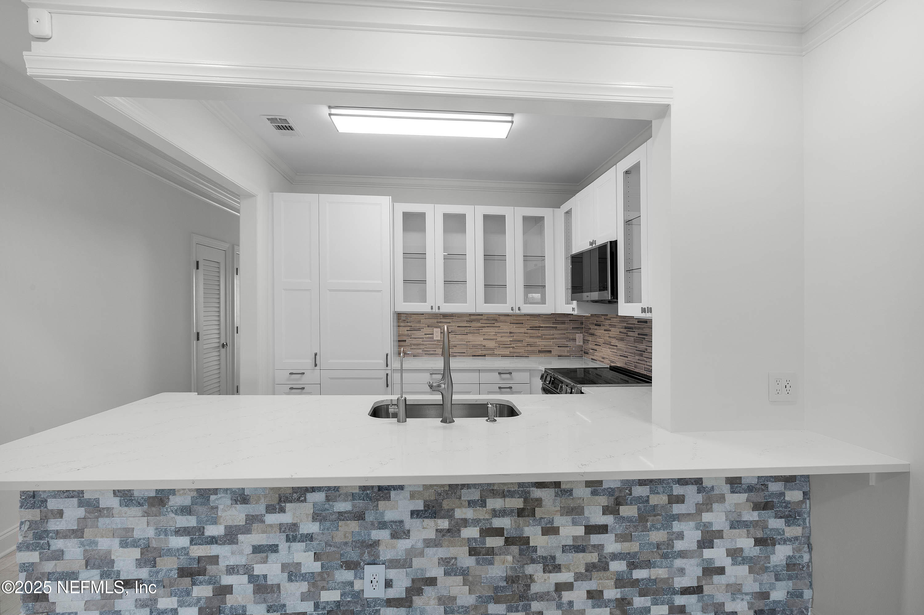 624 Ponte Vedra Boulevard, Unit C8 Ponte Vedra Beach, FL 32082 - Photo 4 of 26 a bathroom with a sink a mirror and shower