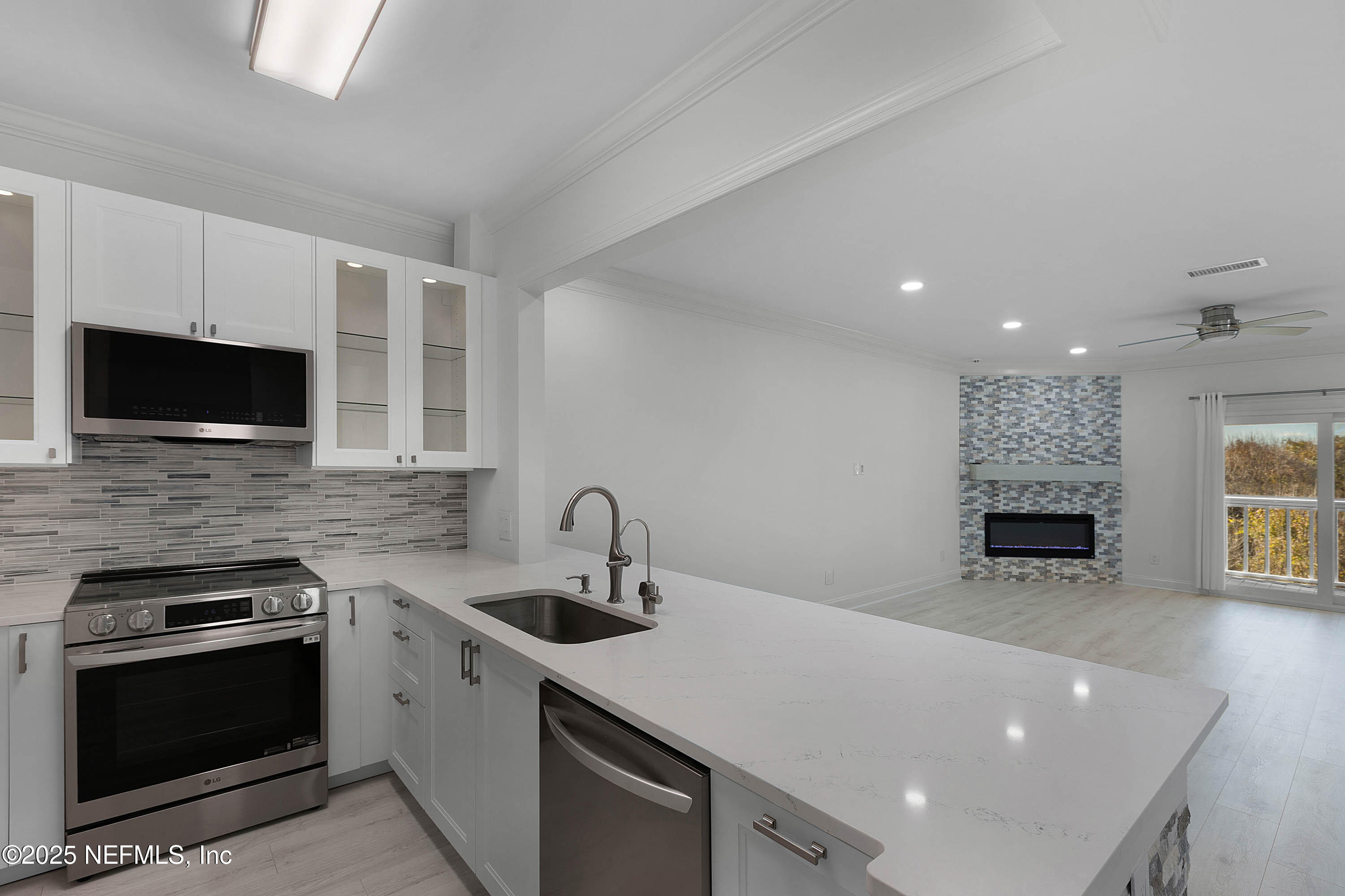 624 Ponte Vedra Boulevard, Unit C8 Ponte Vedra Beach, FL 32082 - Photo 5 of 26 a kitchen with a sink stainless steel appliances and cabinets