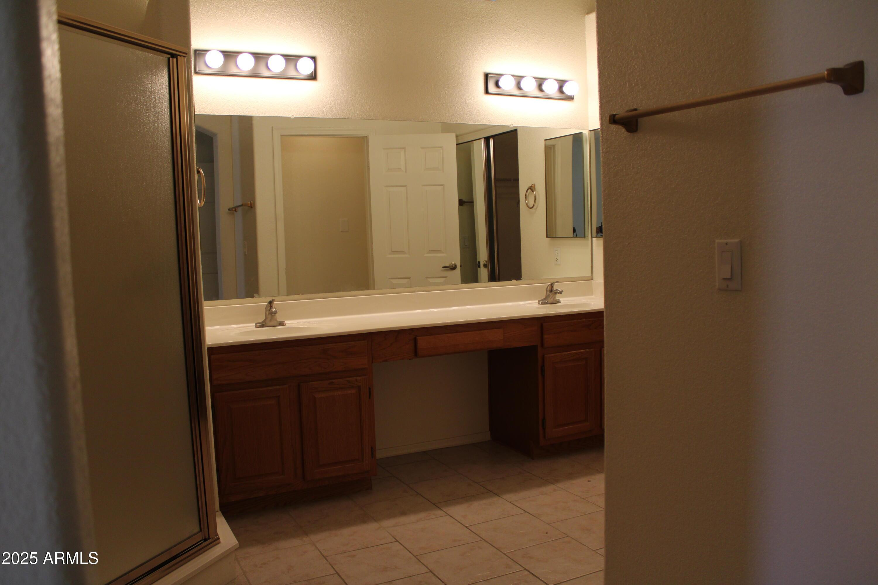 14543 West Bison Path Surprise, AZ 85374 - Photo 13 of 42 a bathroom with a double vanity sink and a mirror