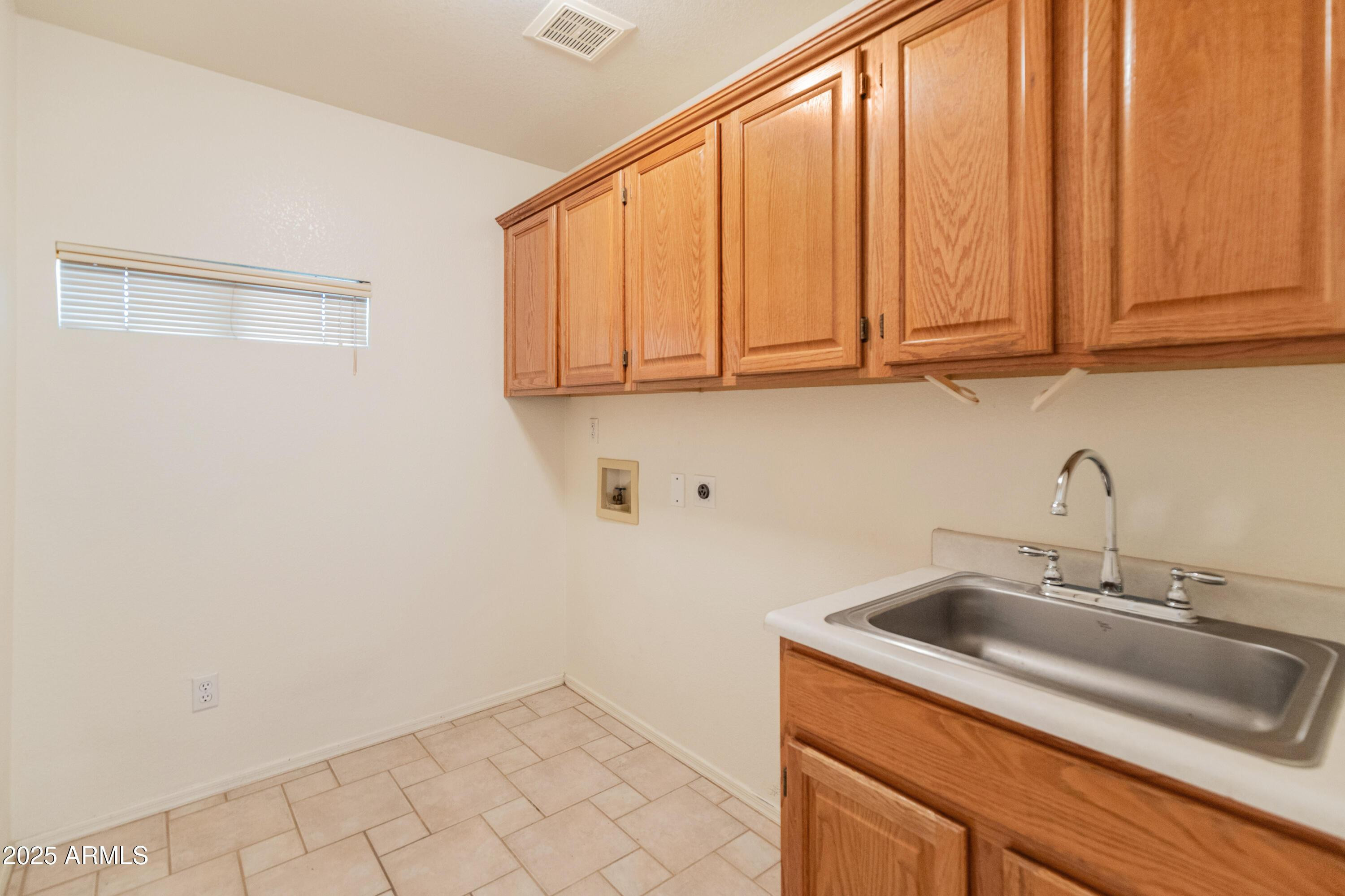 14543 West Bison Path Surprise, AZ 85374 - Photo 14 of 42 a kitchen with a sink cabinets and utility