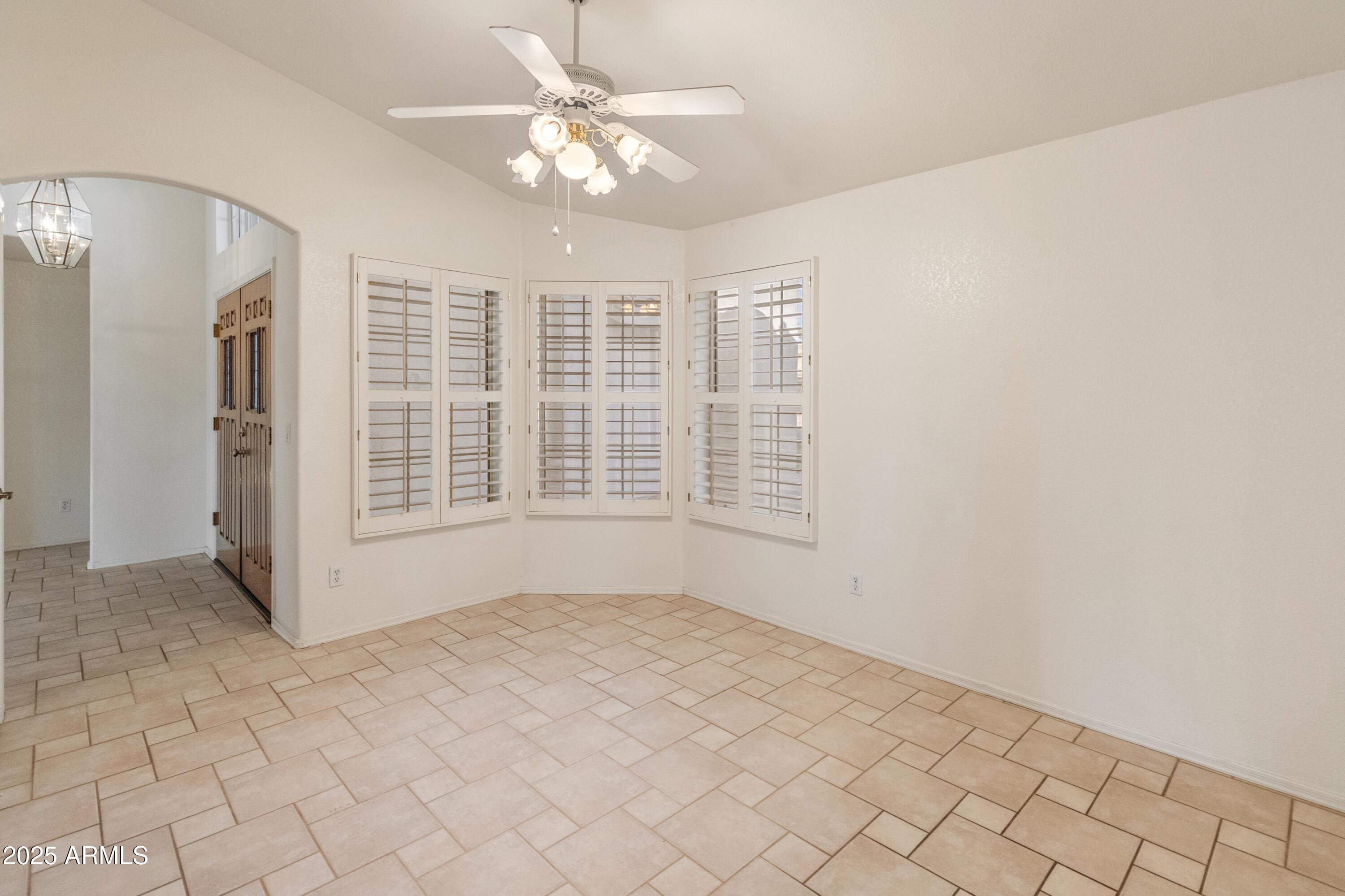 14543 West Bison Path Surprise, AZ 85374 - Photo 16 of 42 an empty room with windows and fan