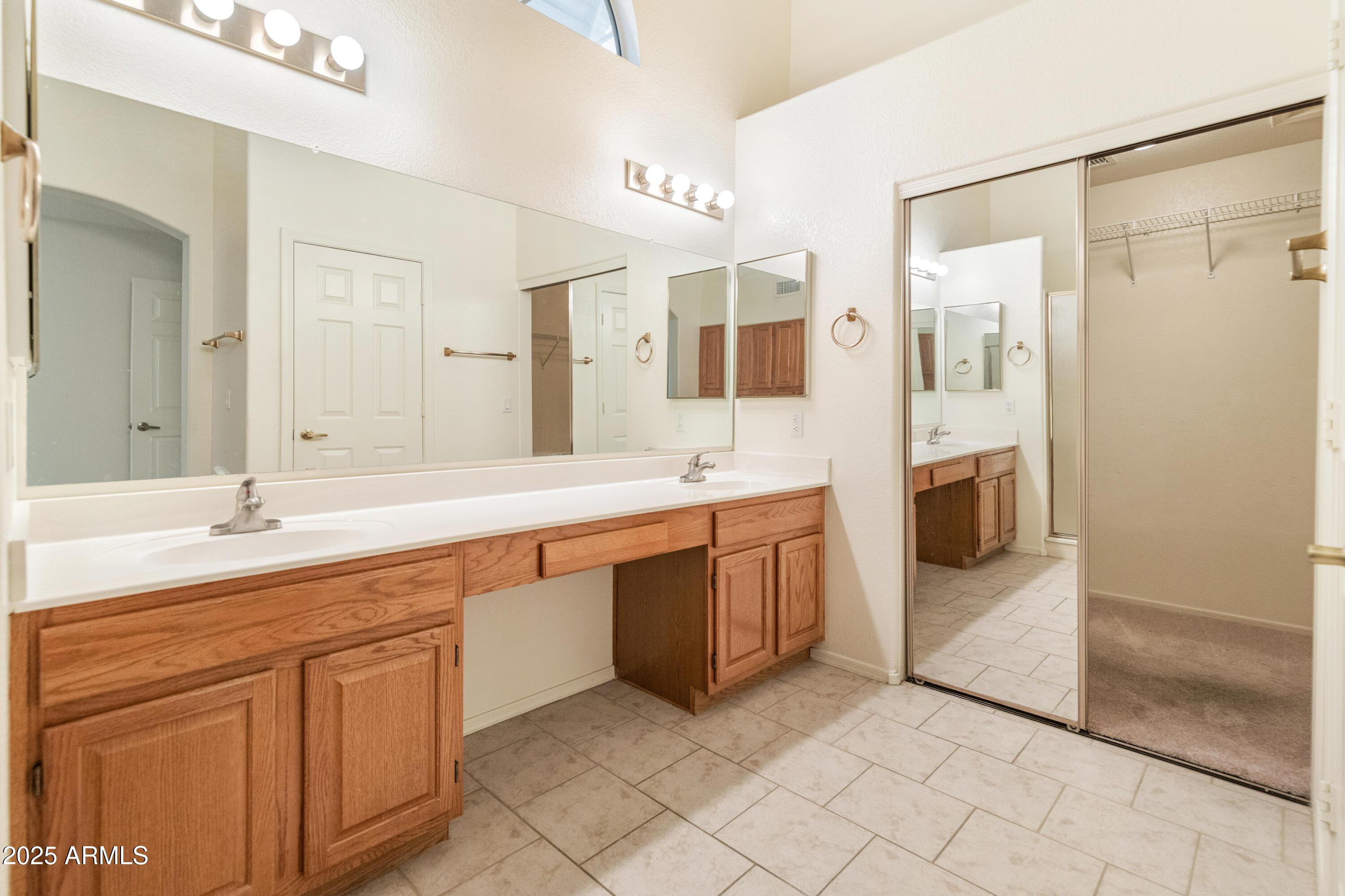 14543 West Bison Path Surprise, AZ 85374 - Photo 18 of 42 a spacious bathroom with a double vanity sink mirror and double