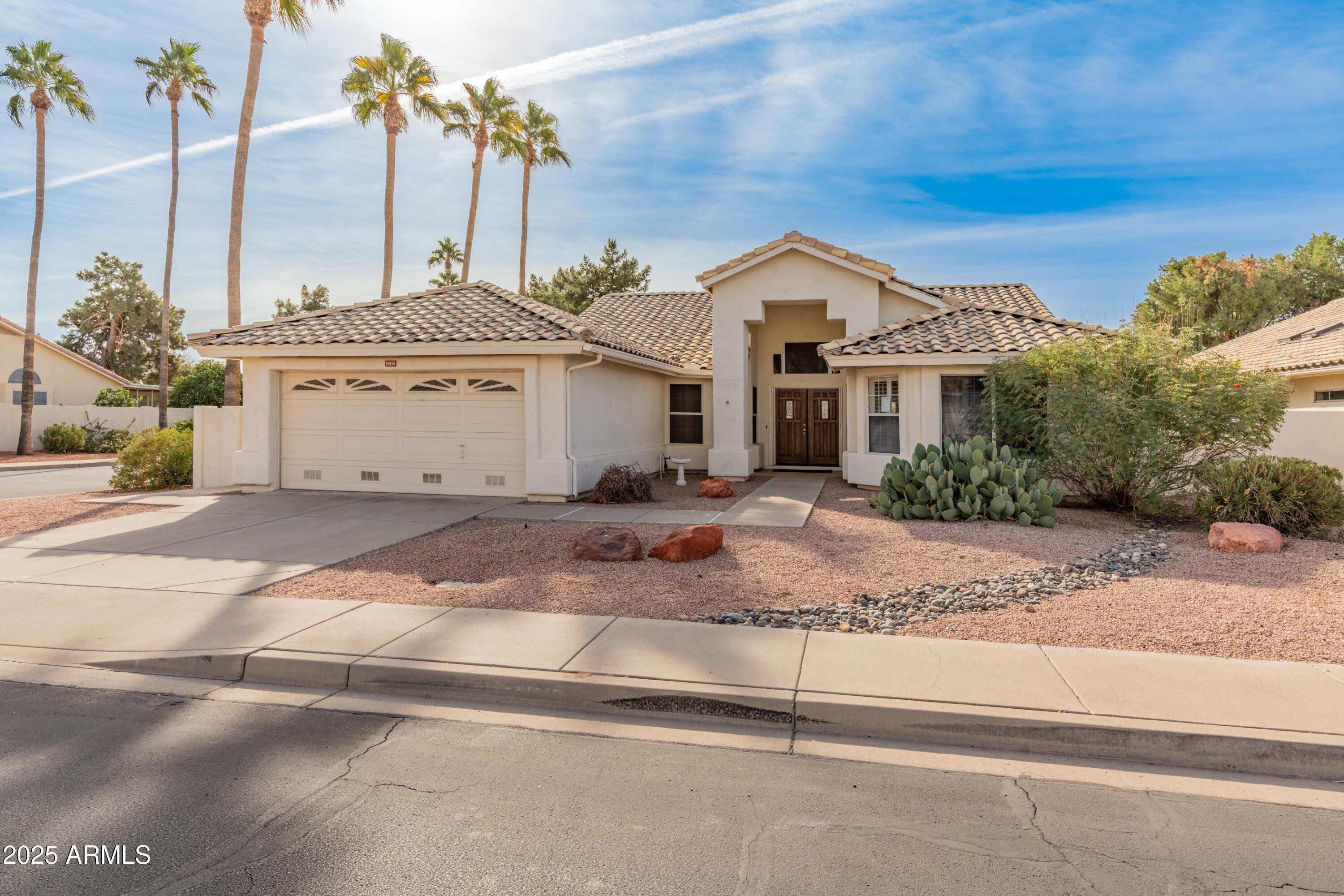 14543 West Bison Path Surprise, AZ 85374 - Photo 2 of 42 a view of a white house with a fountain in front of it