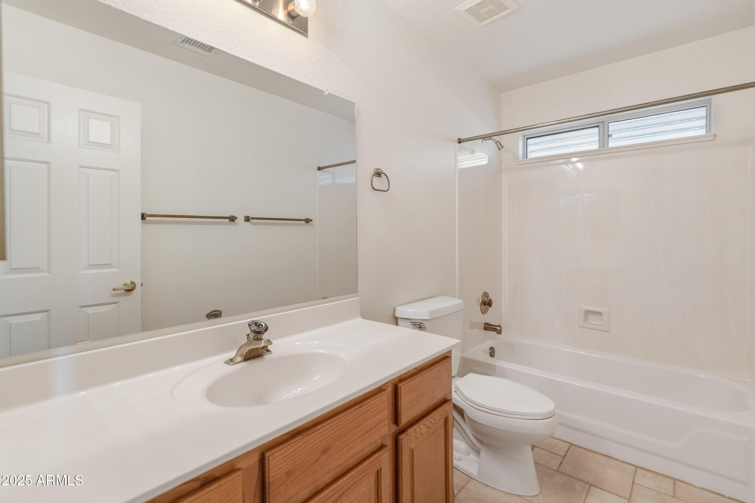 14543 West Bison Path Surprise, AZ 85374 - Photo 21 of 42 a bathroom with a sink toilet vanity and shower