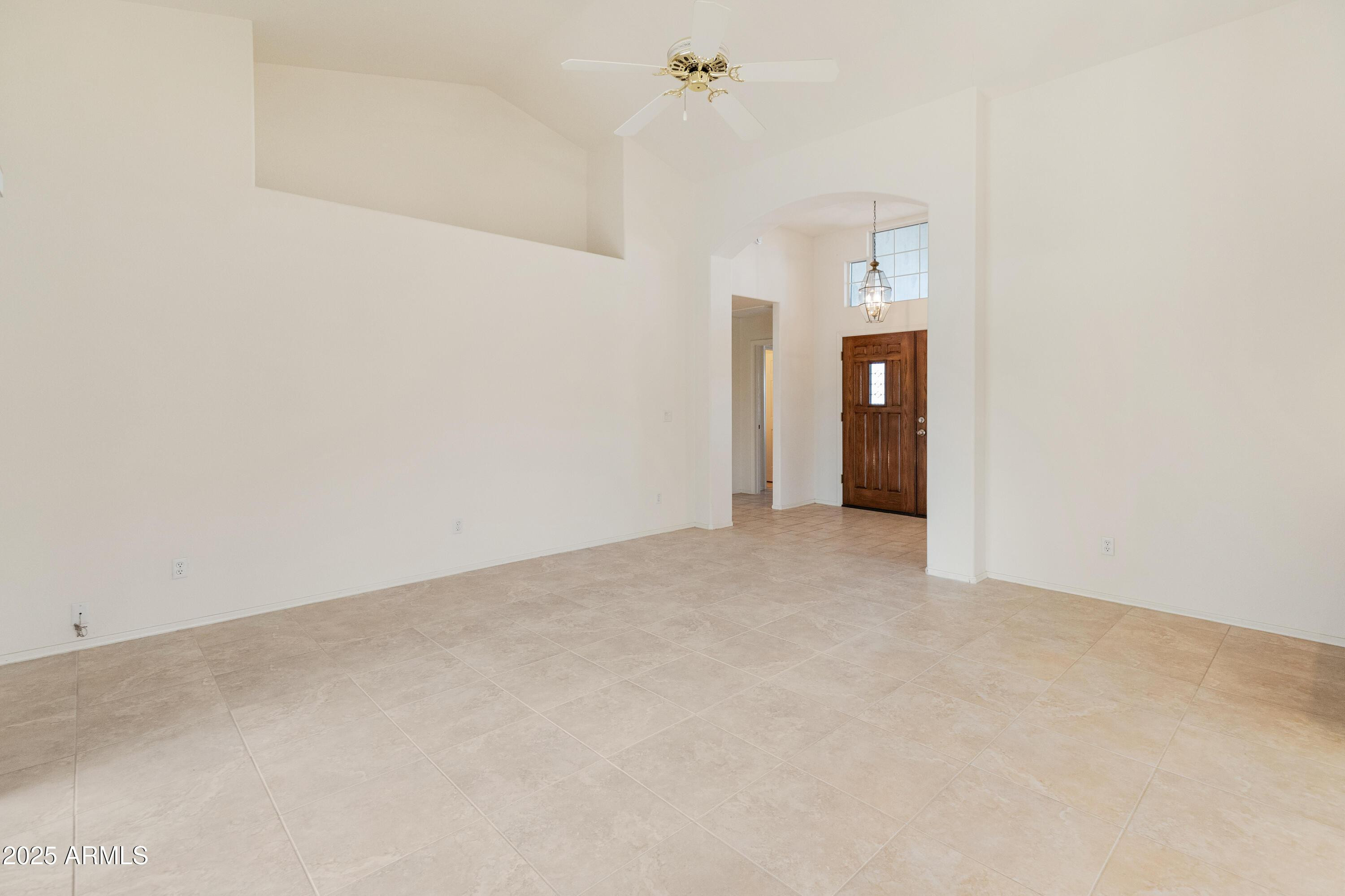 14543 West Bison Path Surprise, AZ 85374 - Photo 26 of 42 en empty room with an entryway and a chandelier