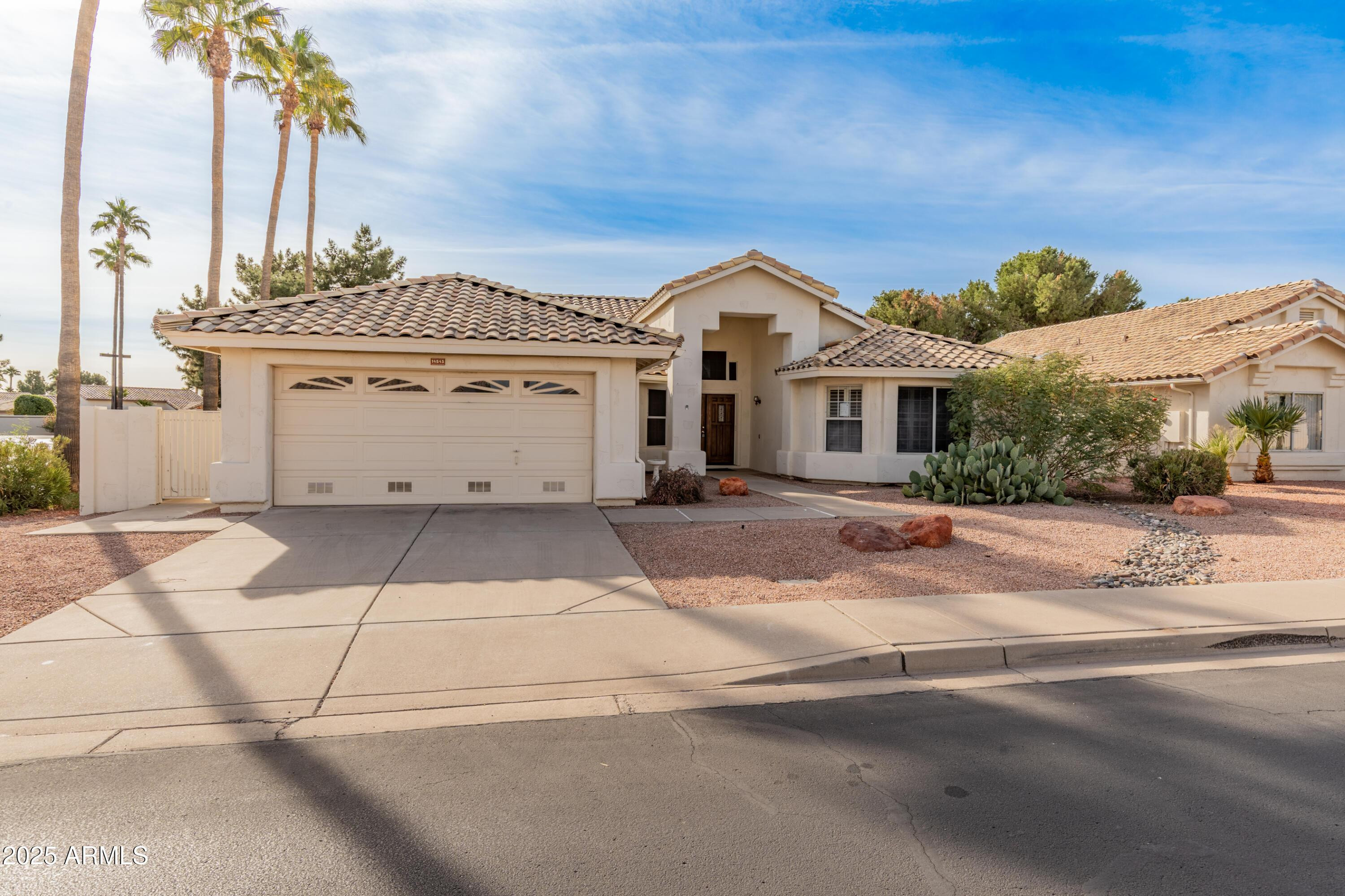 14543 West Bison Path Surprise, AZ 85374 - Photo 3 of 42 a view of a white house with a street