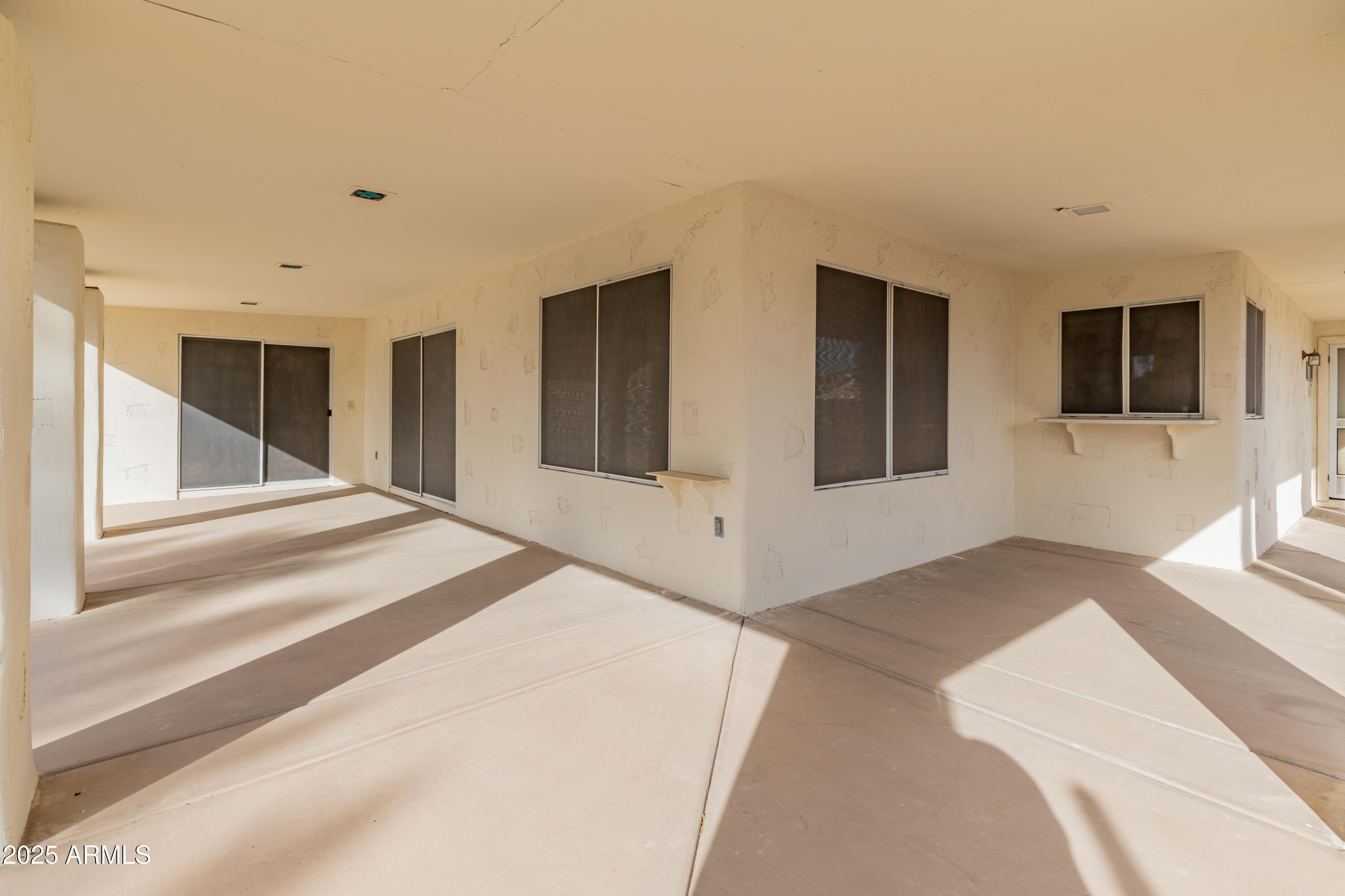 14543 West Bison Path Surprise, AZ 85374 - Photo 32 of 42 a spacious bedroom with a large bed and a flat screen tv