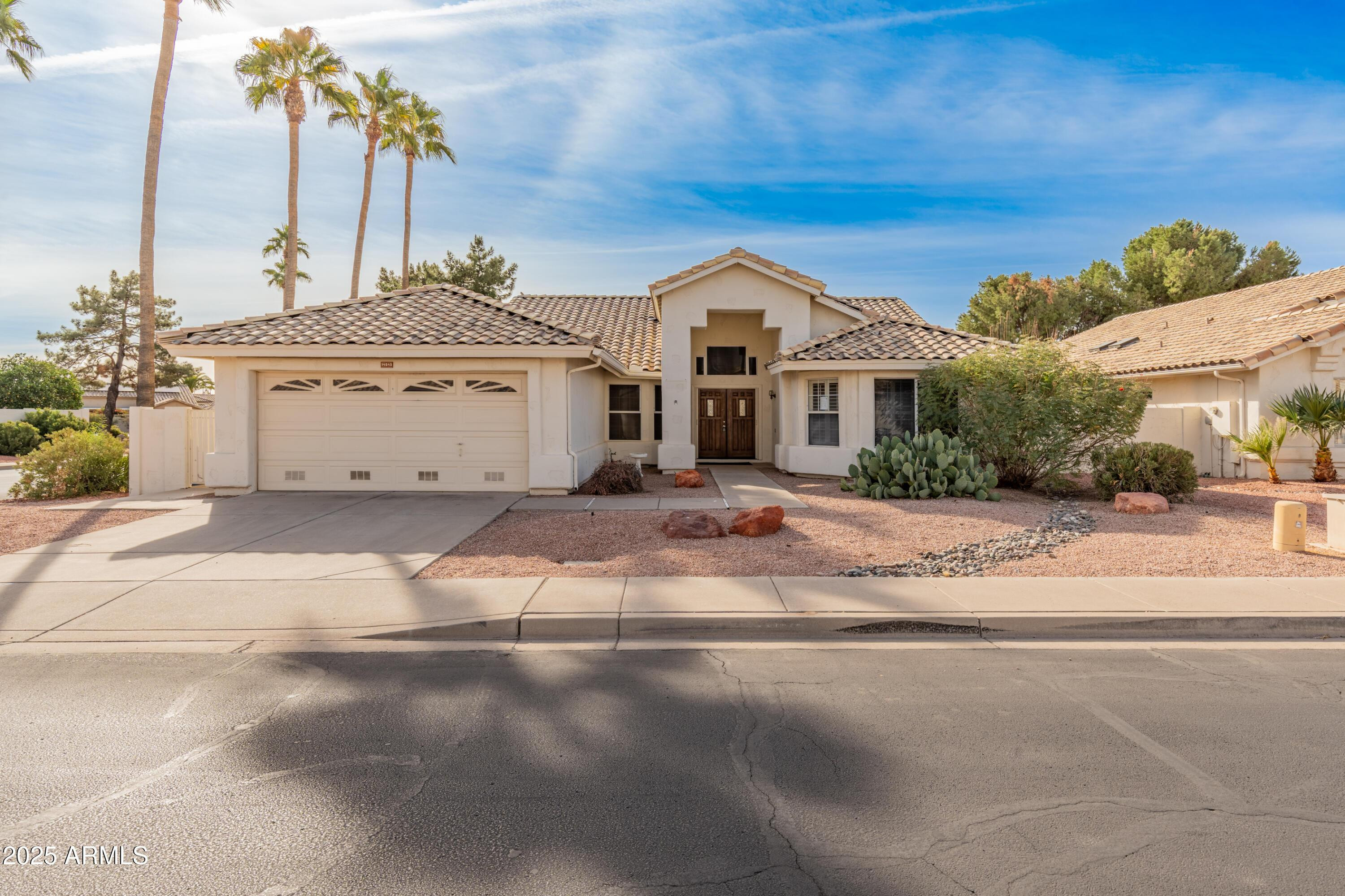 14543 West Bison Path Surprise, AZ 85374 - Photo 4 of 42 a view of a white house with a fountain in front of it