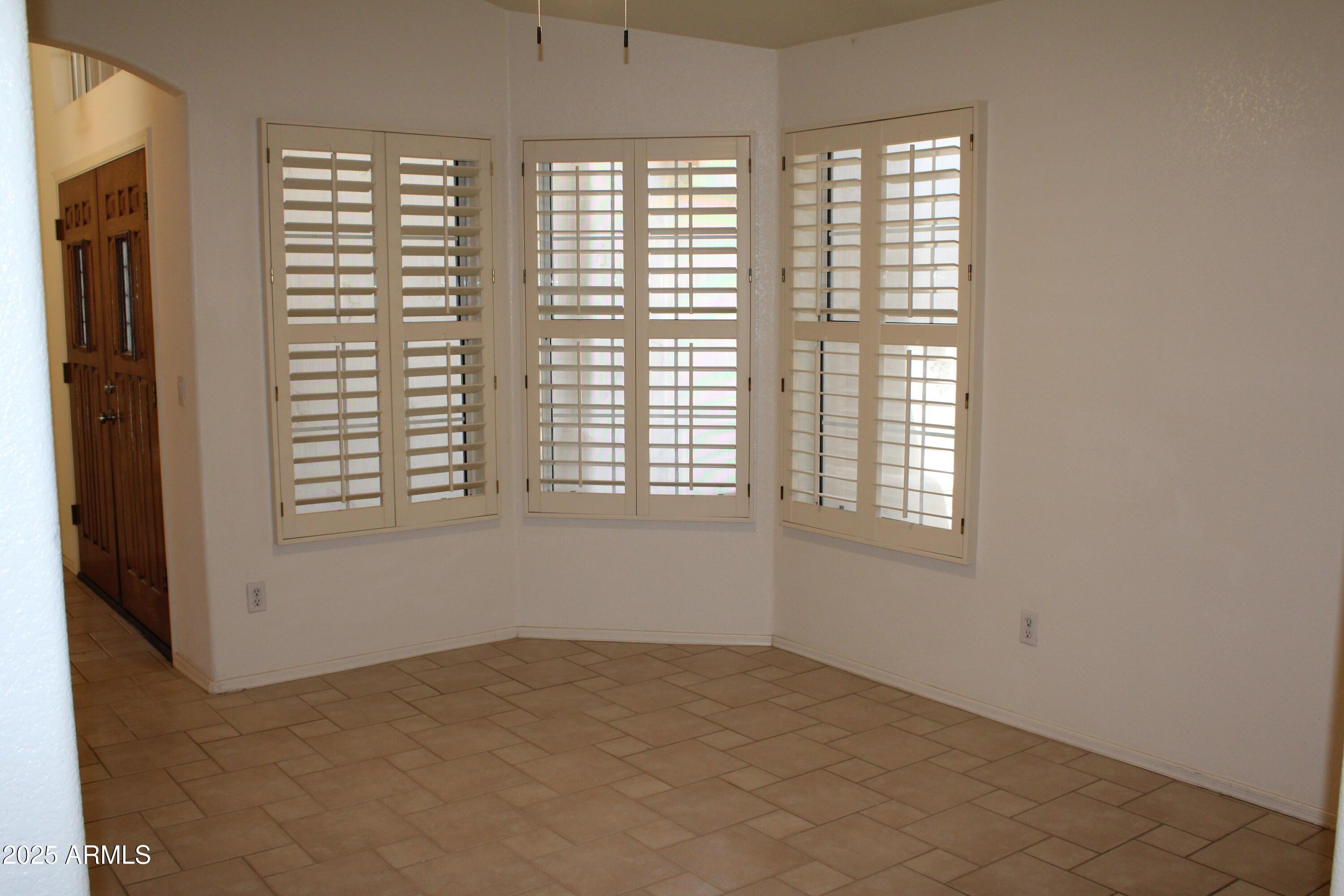 14543 West Bison Path Surprise, AZ 85374 - Photo 9 of 42 an empty room with windows