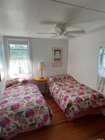 a bedroom with two beds and a window