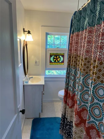 a bathroom with a toilet and a mirror